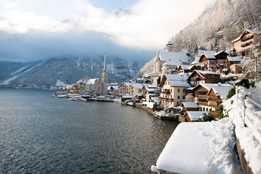 View of snow-covered Hallstatt and the towering Hallstatt church tower in winter