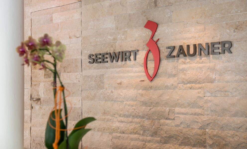 The Seewirt Zauner hotel logo on the wall in the hotel reception area