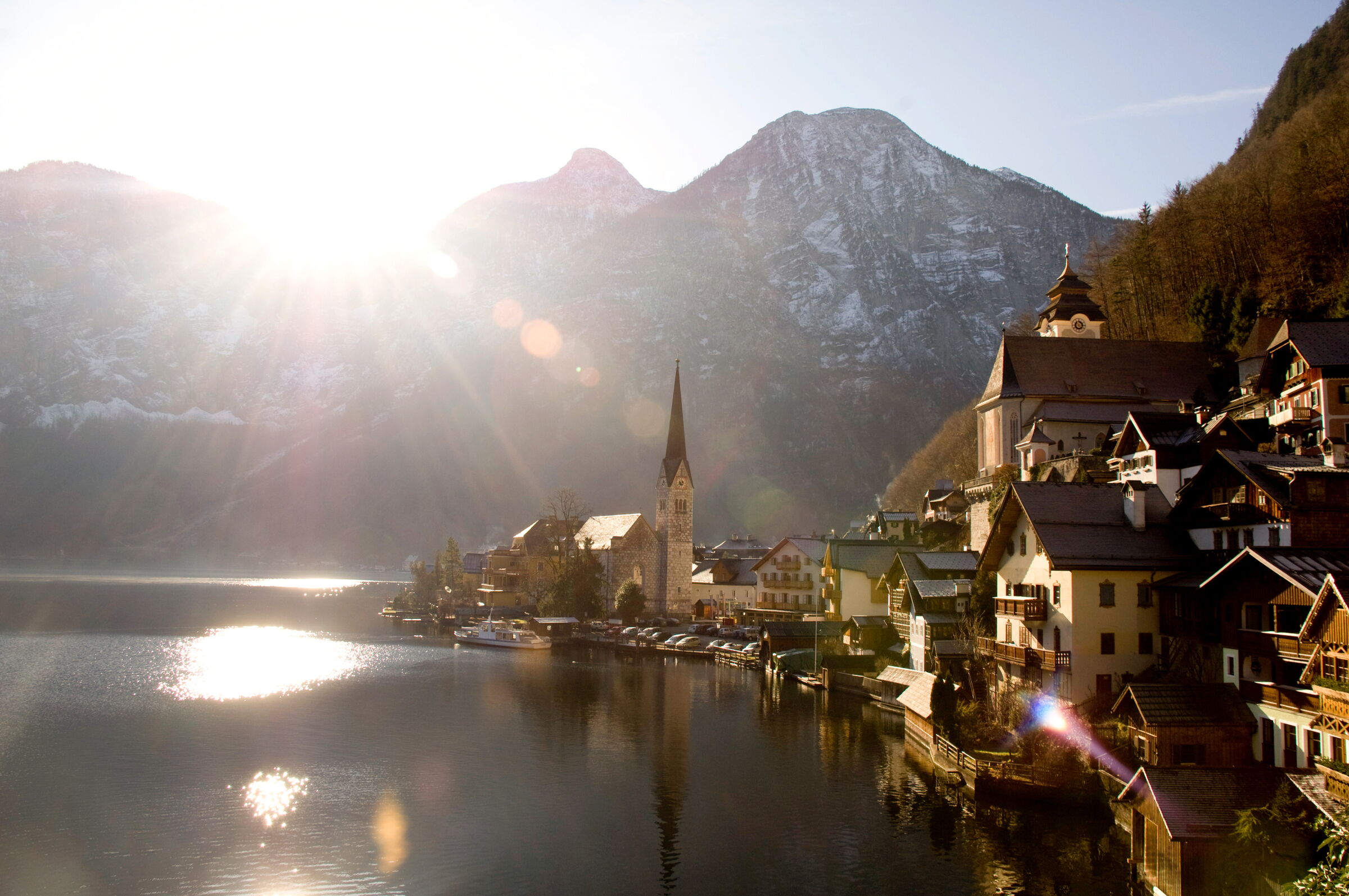 View of the historic town of Hallstatt on Lake Hallstatt as the morning sun shines over the Salzkammergut mountains